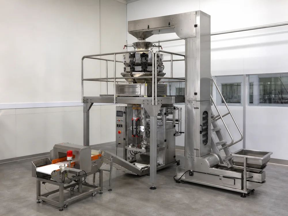 Vertical form fill and seal system producing pouches in a food factory