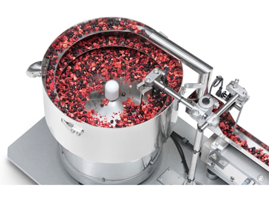 Vibratory bowl feeder for caps and pumps